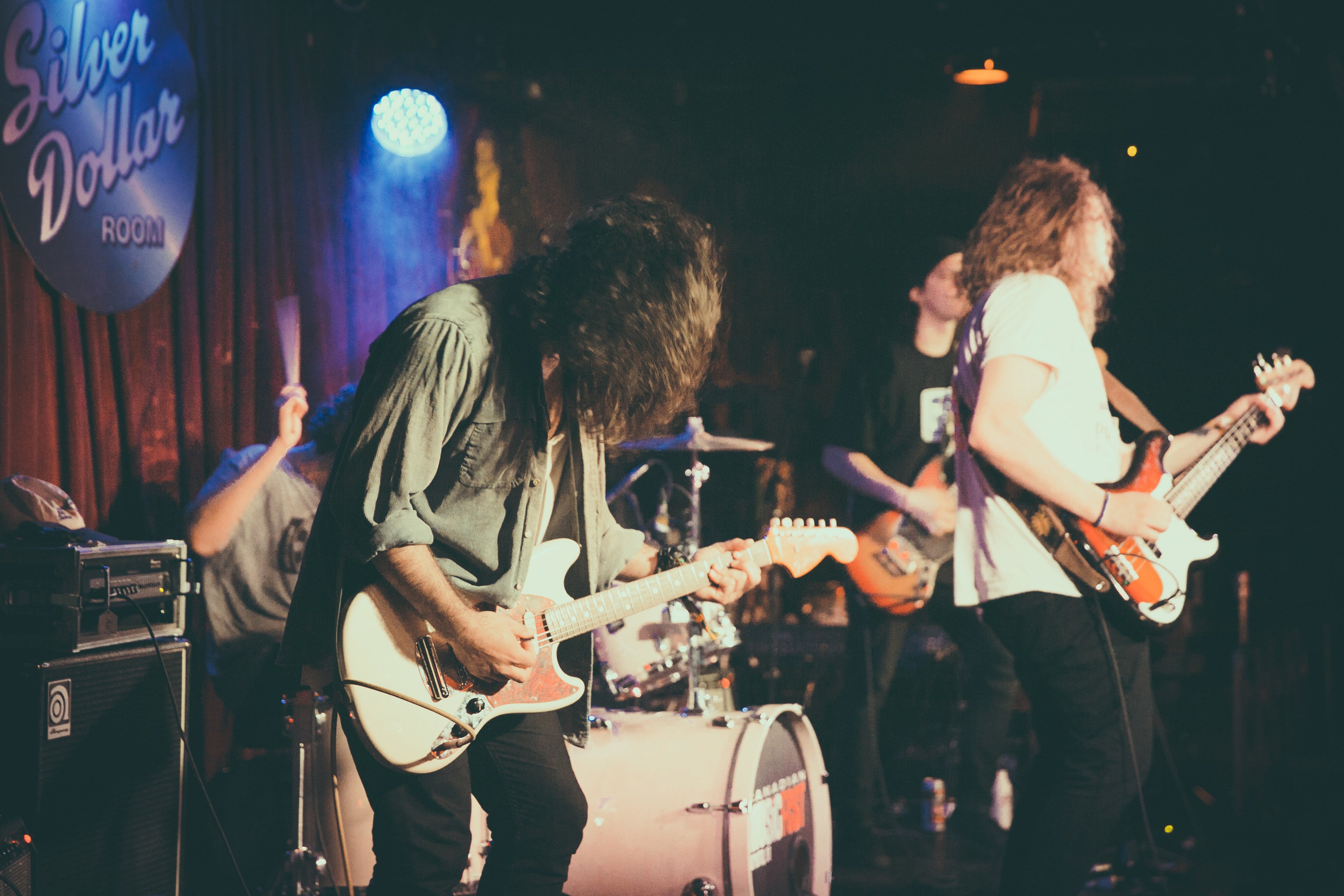 People in a rock band jamming out.